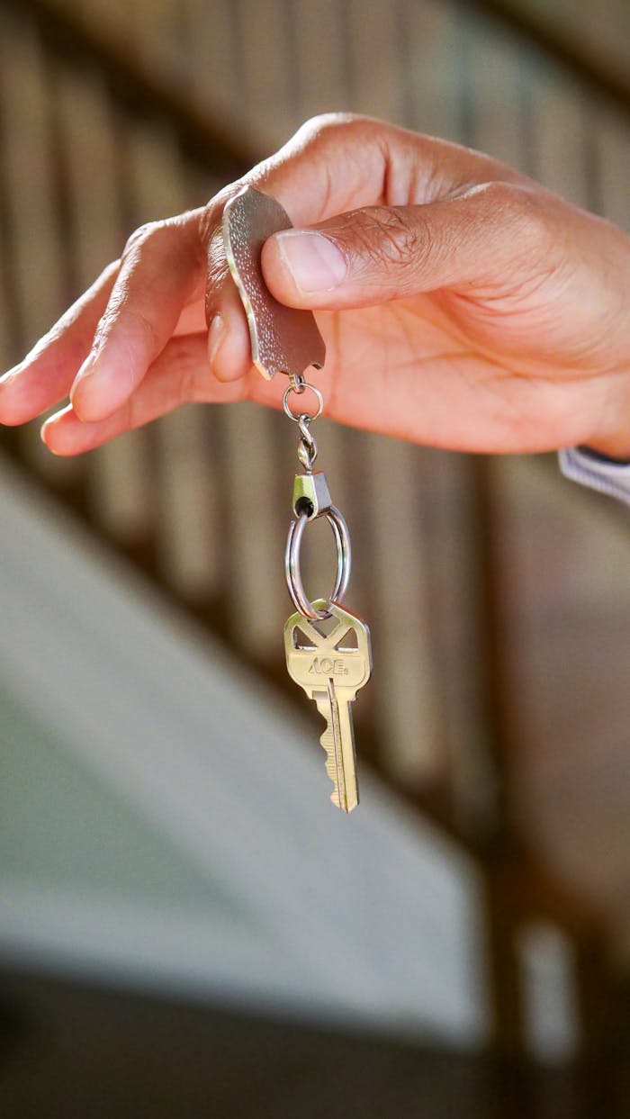 services-01 Close-up of a hand holding a key, symbolizing new homeownership or rental.
